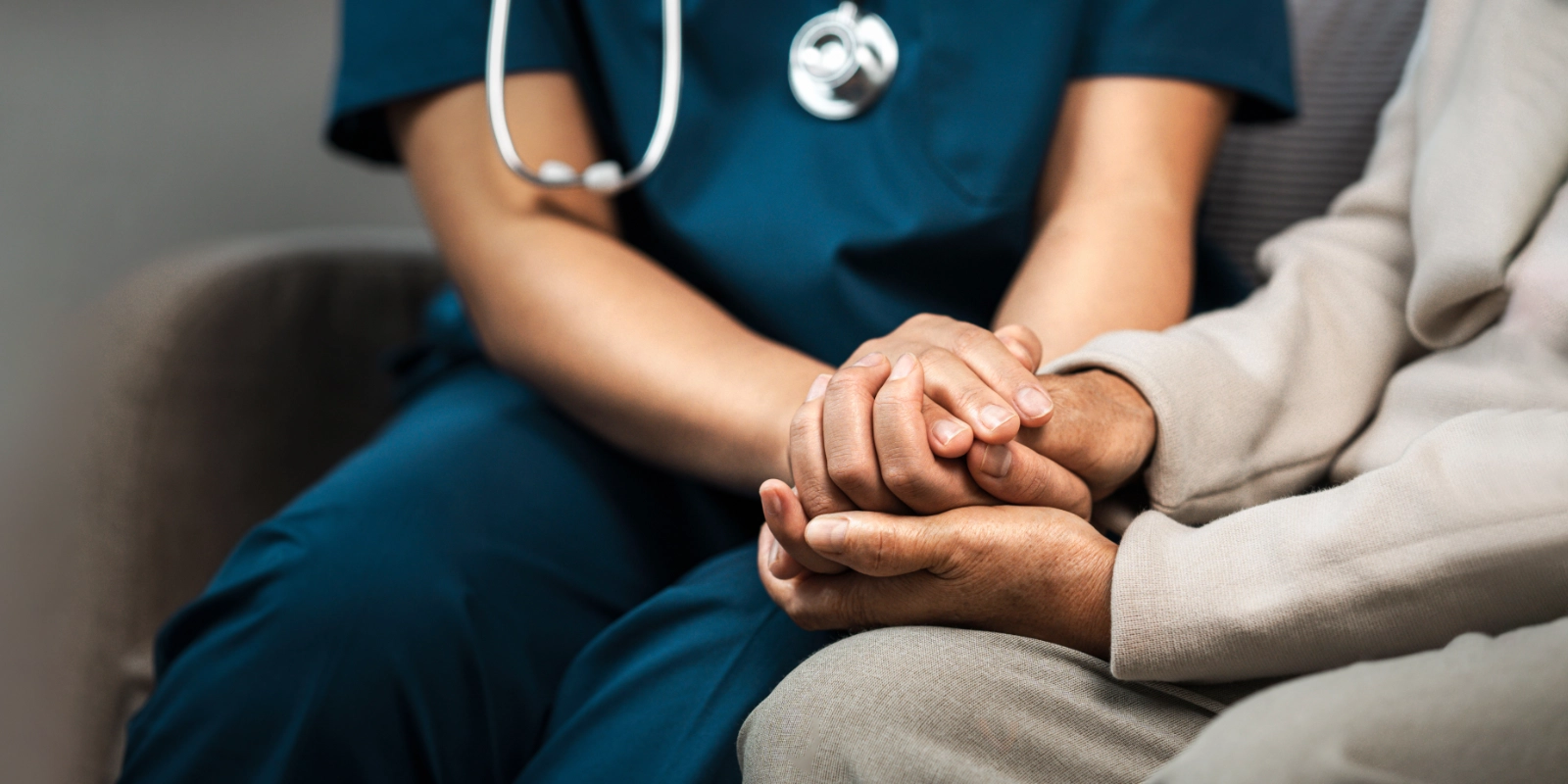 A nurse speaking with a patient in a home setting